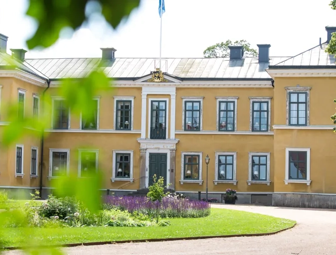 A large yellow building with lots of windows.