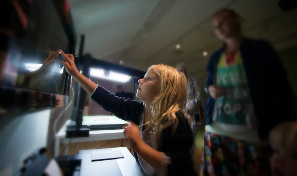 En liten flicka leker med en klocka.