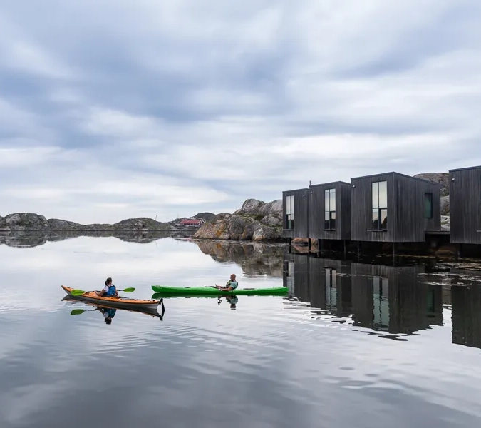 A couple of people in a canoe on a body of water.