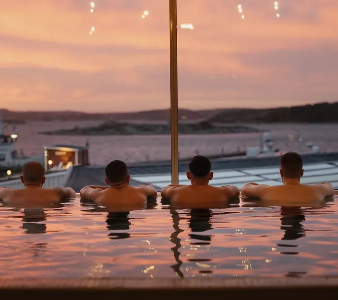 A group of people sitting in a hot tub.
