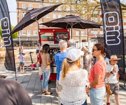 Människor som står vid en utställning