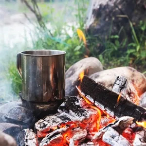 A cup of coffee sitting on top of a fire.
