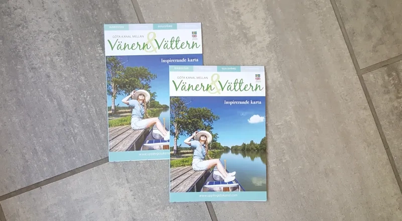 A couple of books sitting on top of a tile floor.