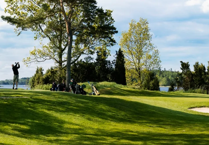 En golfbana med en sjö i bakgrunden.
