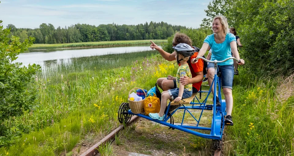 A group of people riding on a small train.