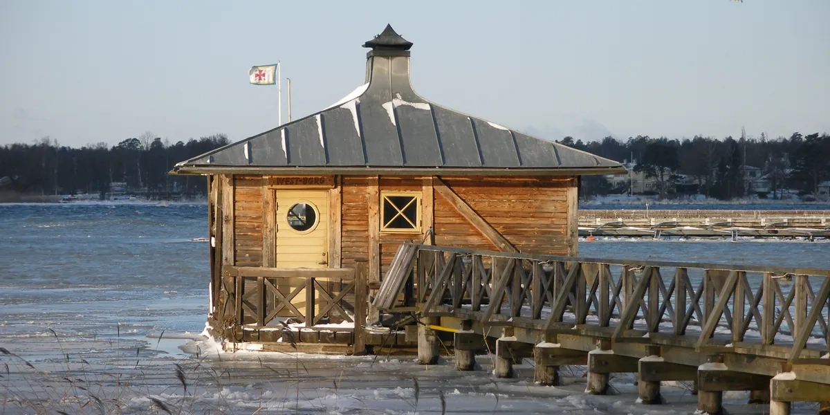 A small wooden building sitting on top of a lake.