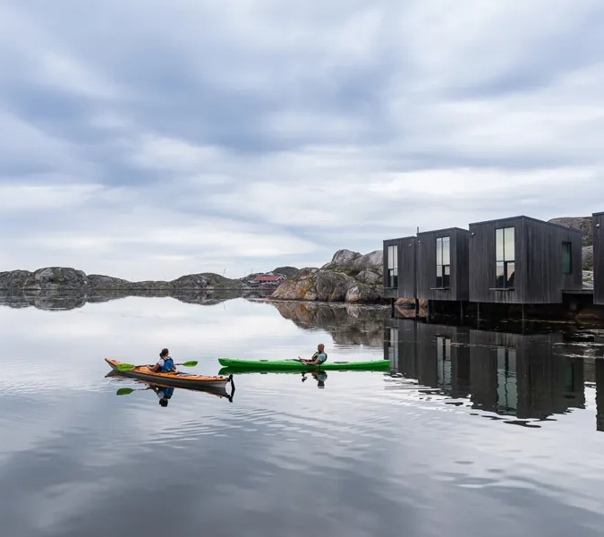 A couple of people in a canoe on a body of water.