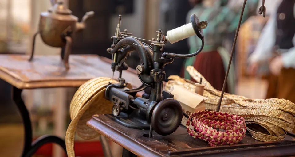 Utställning på Halmens hus. Halmhatt tillverkas på symaskin.