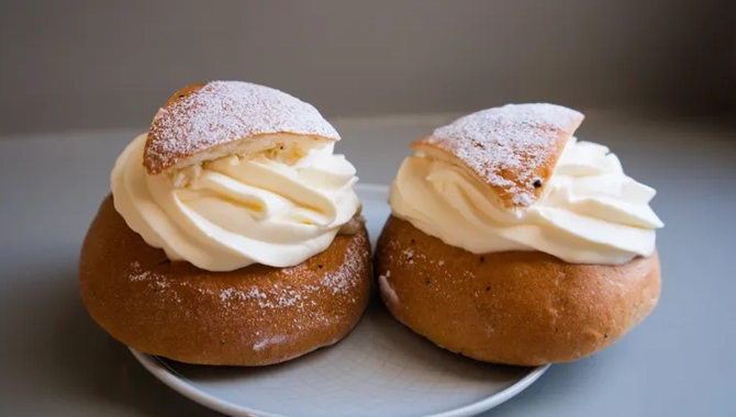 Two pastries on a plate on a table.