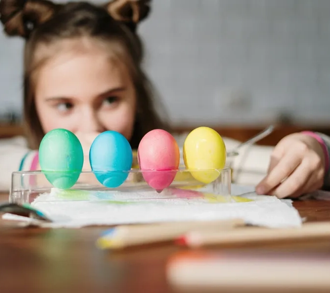 Barn tittar på målade ägg.