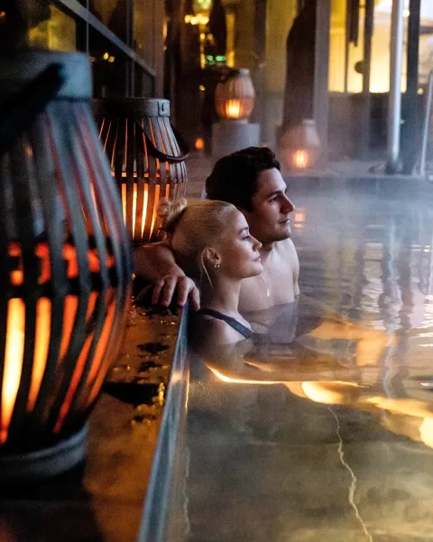 En mann og en kvinne sitter i et boblebad.