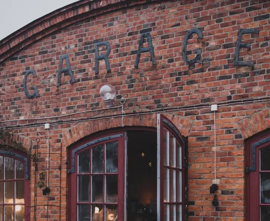 A brick building with red doors and windows.