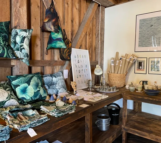 A wooden table topped with lots of pillows.