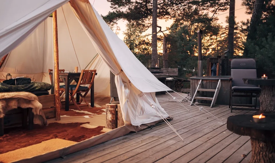 A tent is set up on a wooden deck.