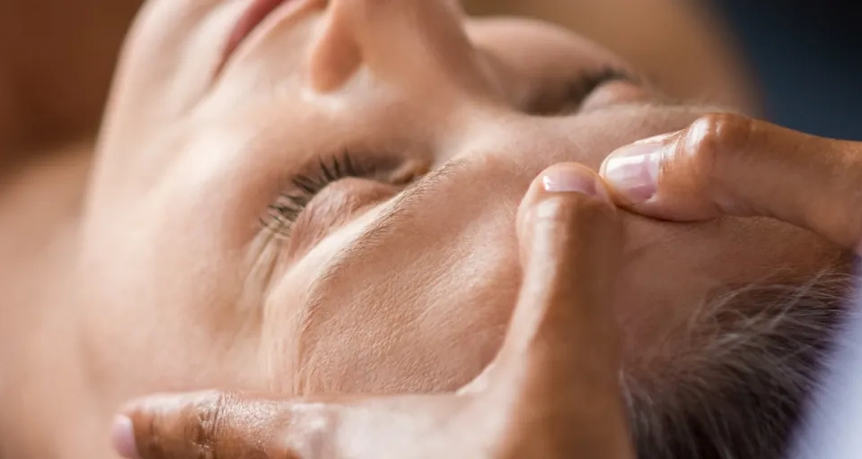 Eine Frau, die eine Gesichtsmassage in einem Spa erhält.