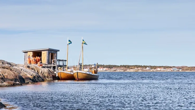 Kastor Boat Trips träbåtar Pollux och Kastor förtöjda vid en sjöbod i skärgården