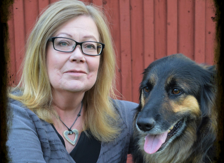 En kvinna och hennes hund poserar för en bild.