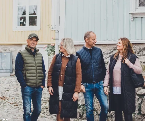 En grupp människor som går längs en kullerstensgata.