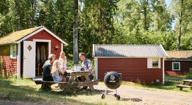 A group of people sitting around a picnic table.