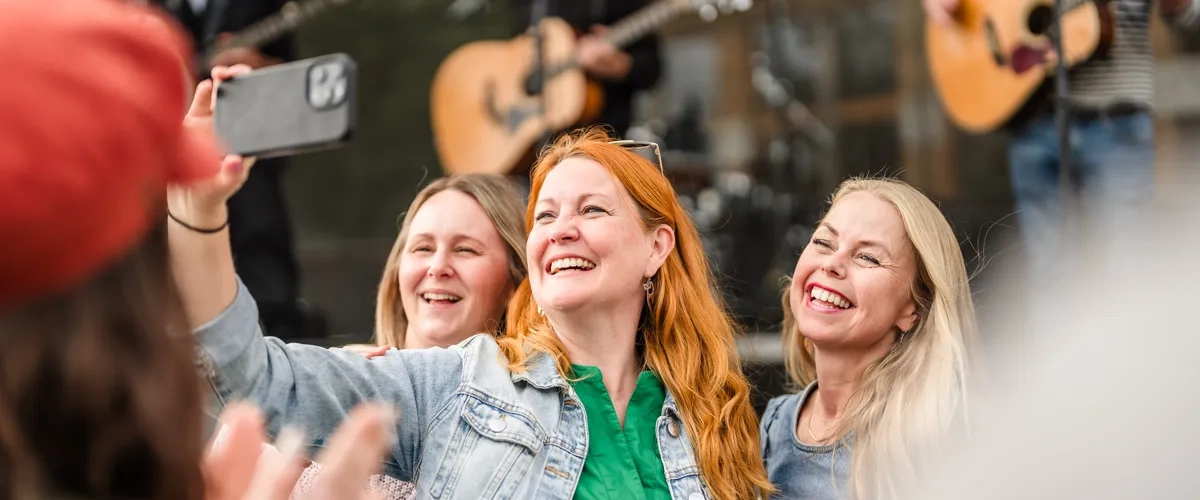 A group of people standing around each other.