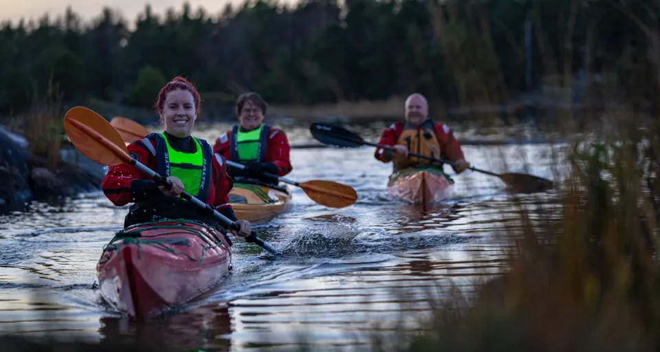 A group of people riding kayaks on top of a river.