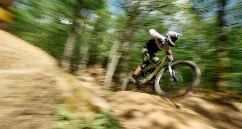 A blurry photo of a person riding a mountain bike
