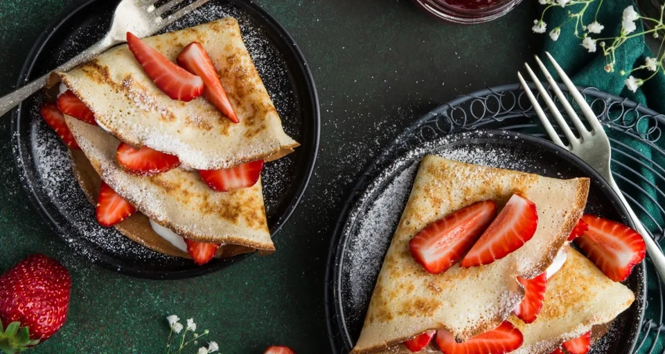A couple of plates of food on a table.