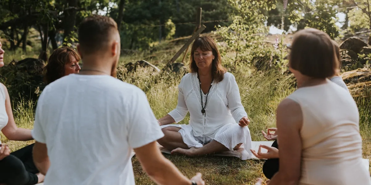 A group of people sitting in a circle doing yoga.