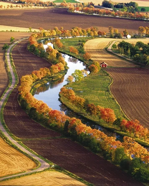 A river running through a lush green countryside.