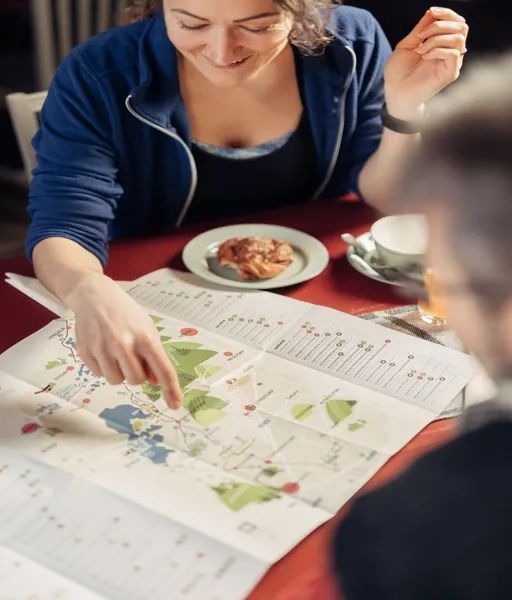 Två människor planerar sin vandring över en fika.