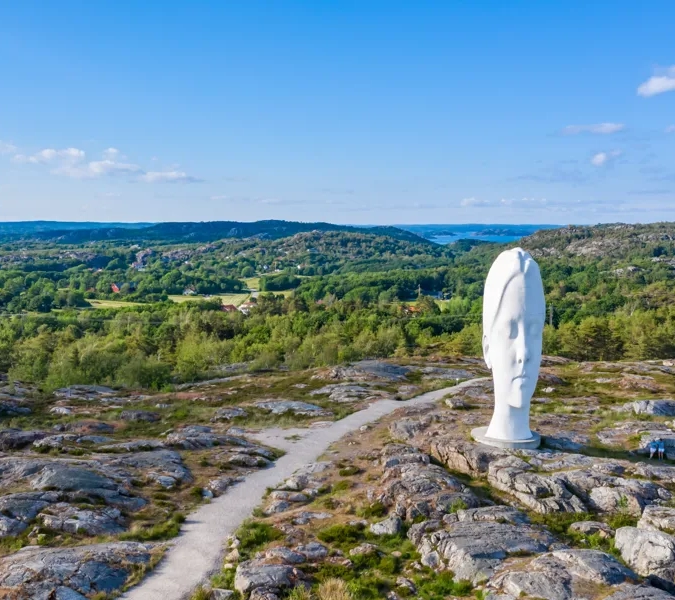 A statue of a person on top of a mountain.