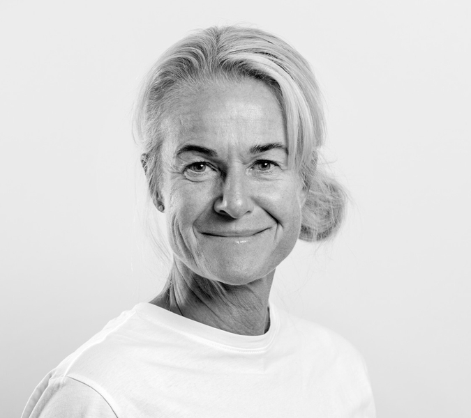 A black and white picture with a smiling woman