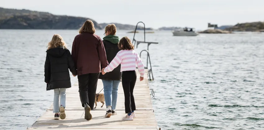 En grupp människor som går längs en pir.