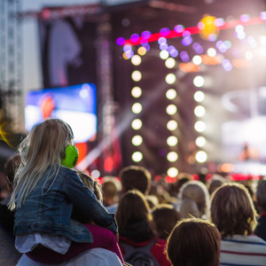 A group of people sitting in front of a stage.