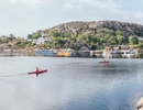 Kvinnor som paddlar kayak i havet.