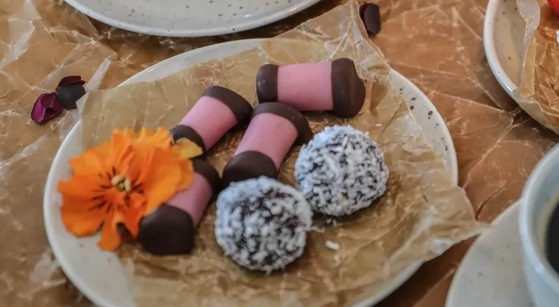 A table topped with plates of food and a cup of coffee.