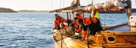 Eine Gruppe von Menschen auf einem Boot im Wasser.