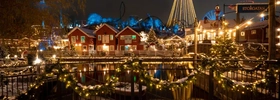Mitten in der Stadt wird ein Weihnachtsbaum beleuchtet.
