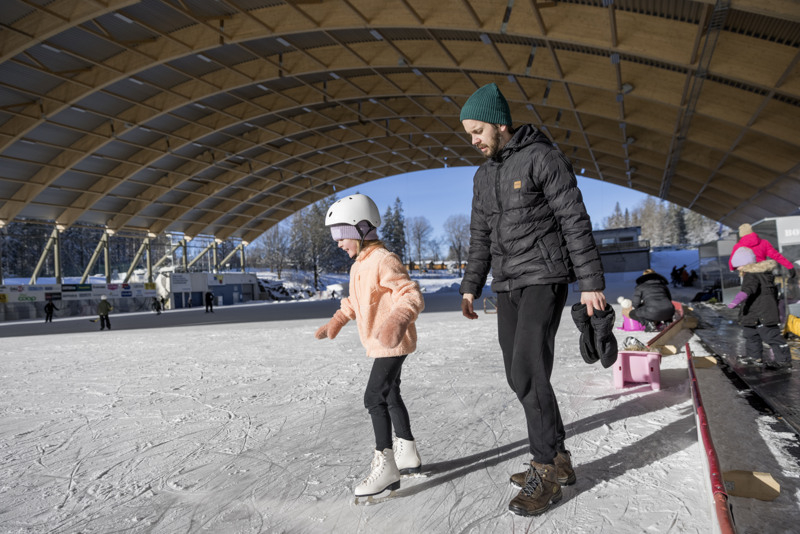 A man and a little girl on a Isrink