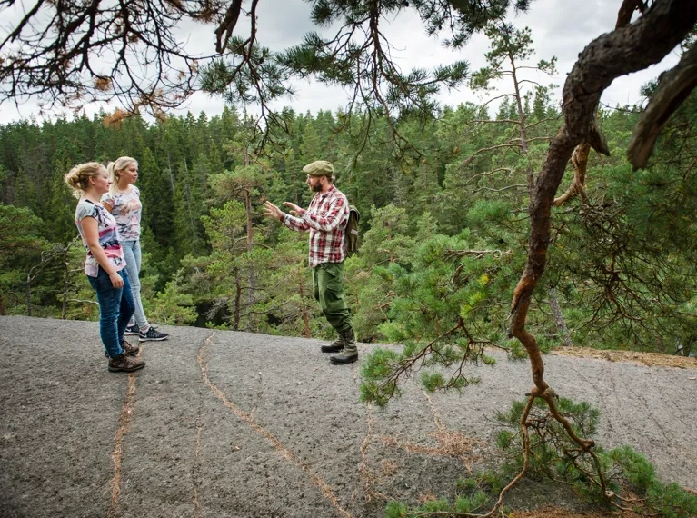 A couple of people standing on top of a hill.