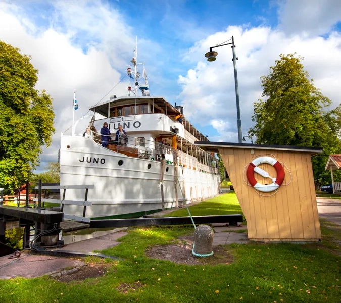 A large boat is docked at a dock.
