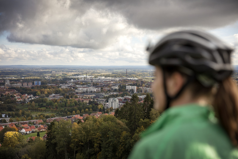 Girl wearing a bike helmet looking out over Skövde.