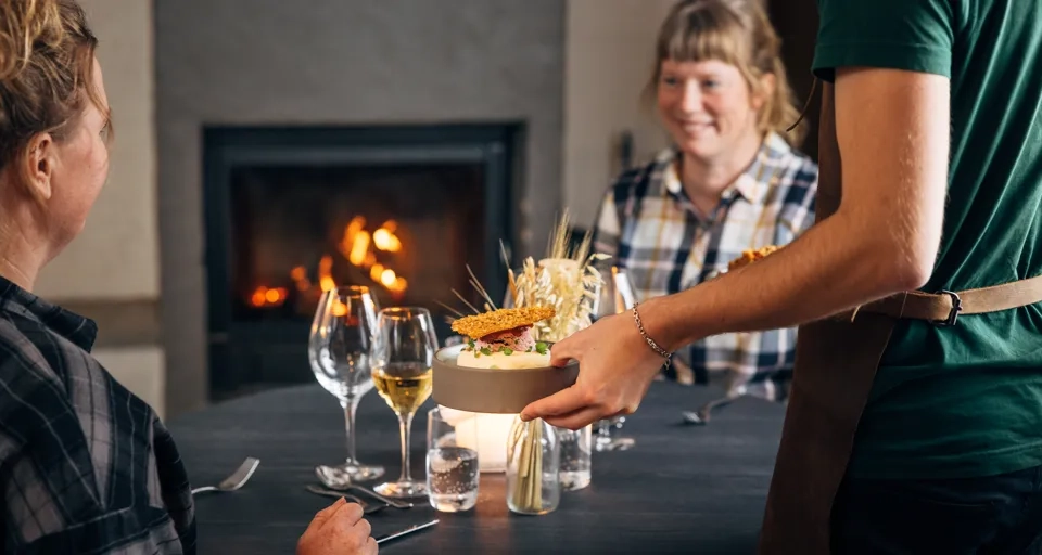 A group of people sitting around a table with wine glasses.