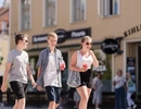 A group of people walking down a street.