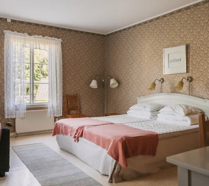 A bedroom with a bed and a chair in it.