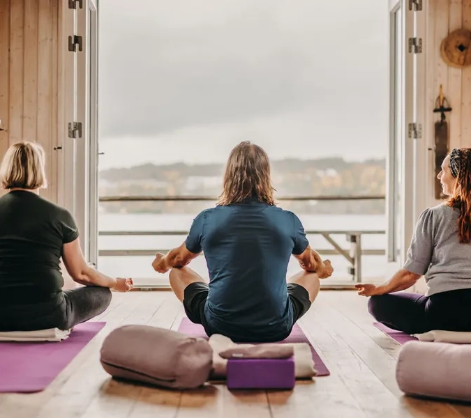 A group of people sitting on top of yoga mats.