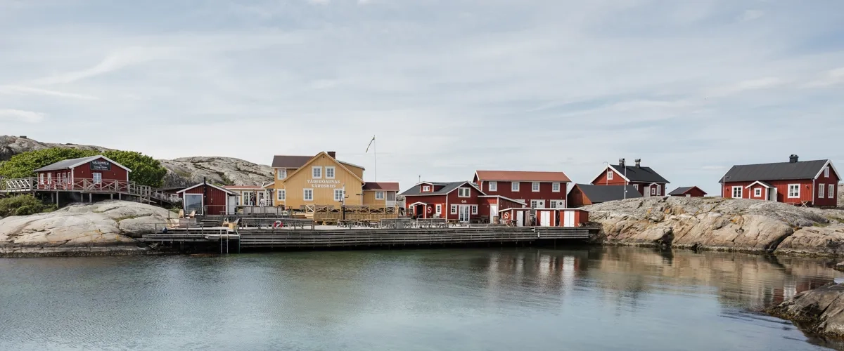 A body of water with houses in the background.