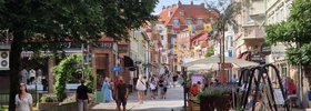 En gata i en stad med människor som går längs den.