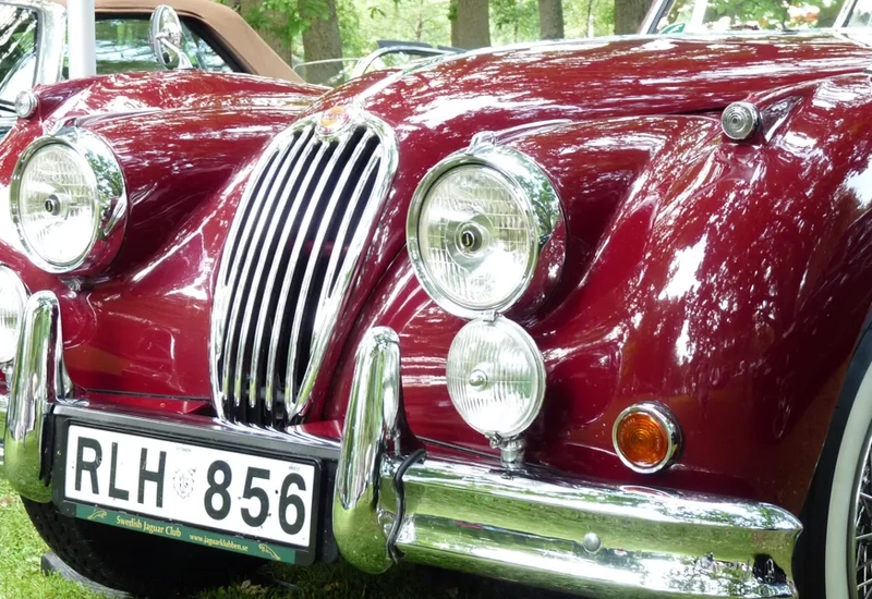 A close up of a car parked on a grass field.