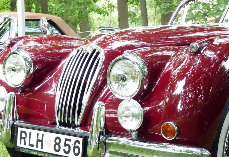 A close up of a car parked on a grass field.